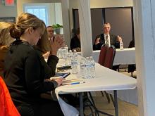 Secretary Lindsay Kurrle in foreground on left. Governor Scott in background on right.