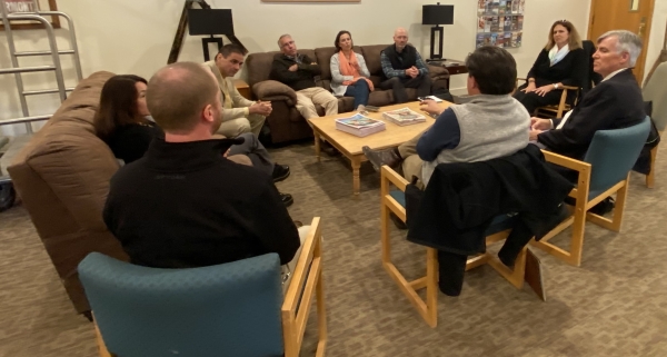 group sitting in circle in chairs