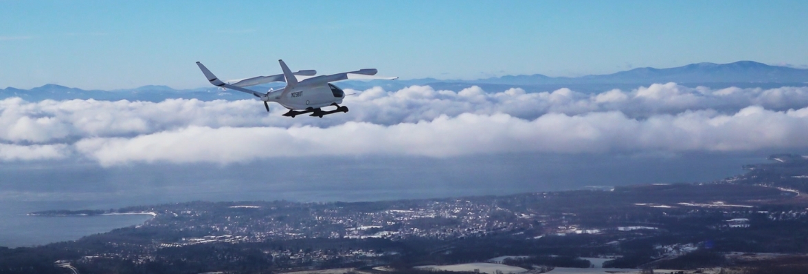 Aircraft flying in front of mountains.