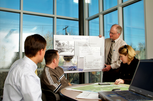 Four people meetings around a whiteboard 