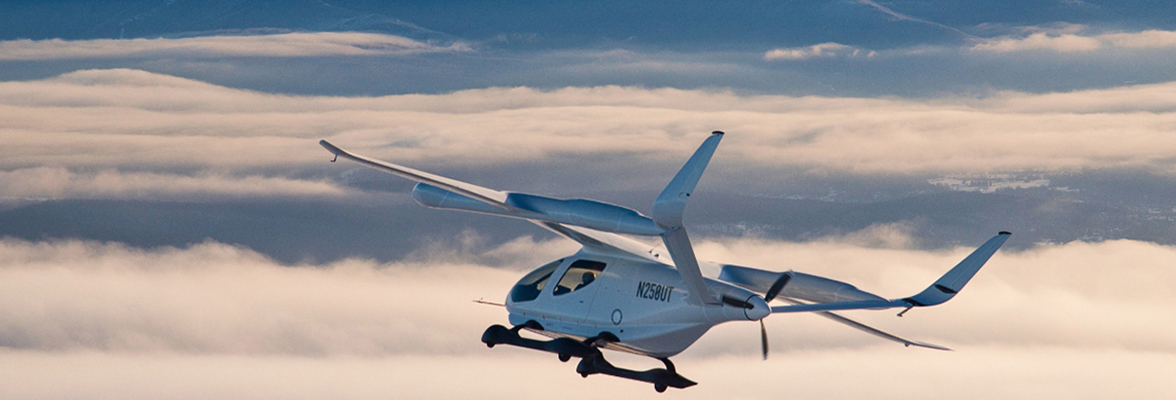 Aircraft flying in front of mountains.