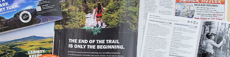 <p>A magazine spread features a woman hiking on a lush trail above the prominent text</p>