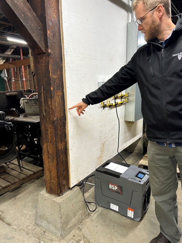 Henry Witte points to high water mark on the wall